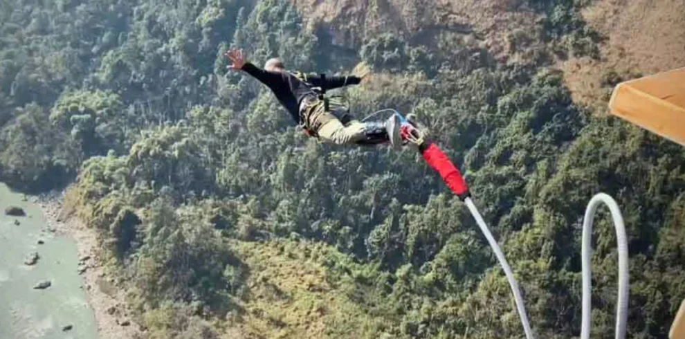 An adventurer jumping from a bridge for bungee jumping in the Nepal mountains.